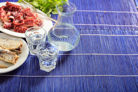 Glasses of ouzo and appetizers