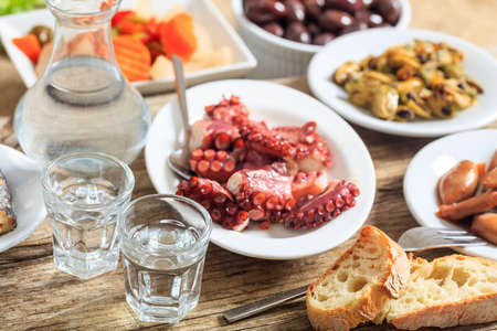 Glasses of ouzo and appetizersの写真素材