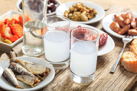 Glasses of ouzo and appetizersの写真素材