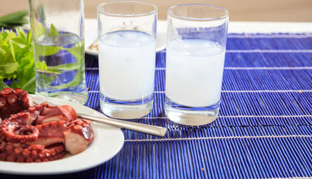 Glasses of ouzo and appetizersの写真素材