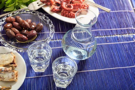 Glasses of ouzo and appetizersの写真素材