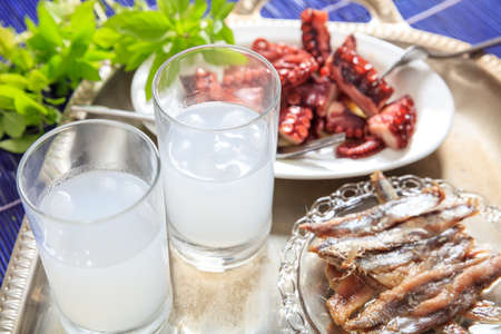 Glasses of ouzo and appetizersの写真素材