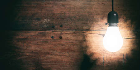 3d rendering light bulb hanging on wooden backgroundの写真素材