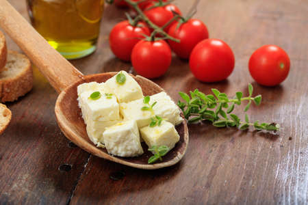 Greek feta cheese pieces on wooden backgroundの写真素材