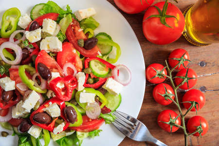 Fresh greek salad on wooden backgroundの写真素材
