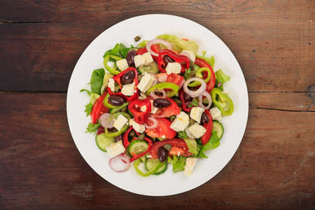 Fresh greek salad on wooden backgroundの写真素材