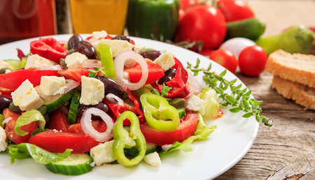 Fresh greek salad on wooden backgroundの写真素材