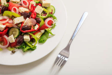 Fresh greek salad on white backgroundの写真素材