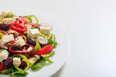 Fresh greek salad on white backgroundの写真素材