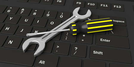 3d rendering spanner and screwdriver on a black keyboardの写真素材
