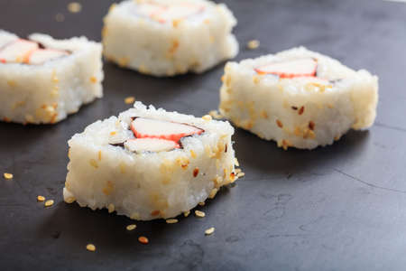 Sushi rolls on a black plateの写真素材