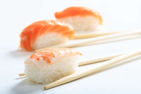 Nigiri sushi and sticks on white backgroundの写真素材