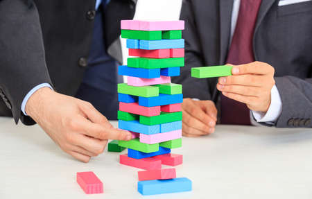 Hands playing wooden blocks game