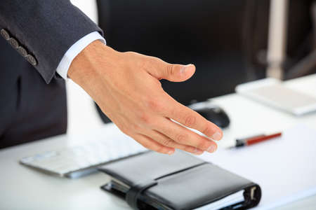 Businessman offering handshake in an office