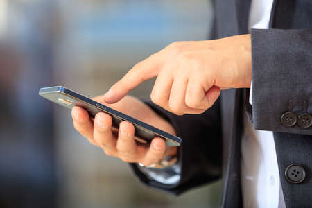 Businessman holding a mobile phoneの写真素材