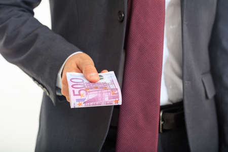 Man in suit offering money