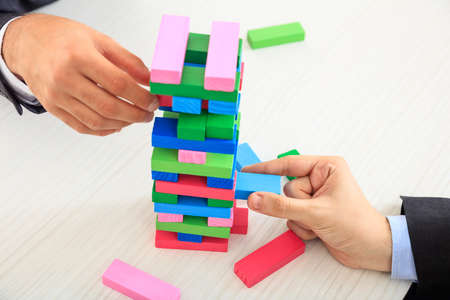 Hands playing wooden blocks gameの写真素材