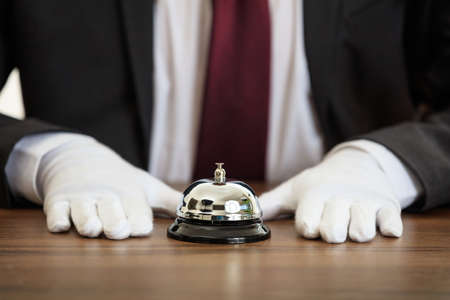 Butler service bell on a wooden surfaceの写真素材