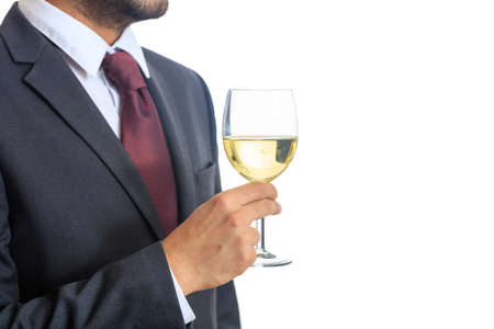 Man in suit holding a glass of white wineの写真素材