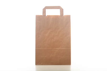 Brown paper shopping bag isolated on white backgroundの写真素材