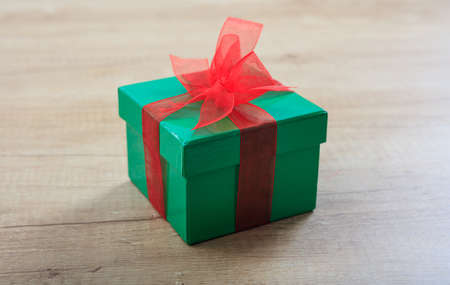 Green gift box on wooden backgroundの写真素材
