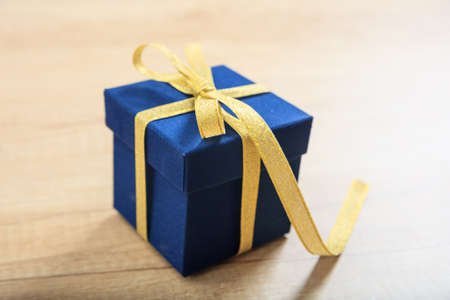 Blue gift box on wooden backgroundの写真素材