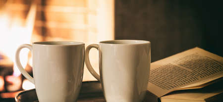 Cups of coffee infront of a fireplaceの写真素材