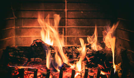 Burning logs in a fireplaceの写真素材