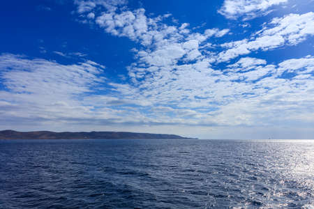 Blue sky with clouds and sea backgroundの写真素材