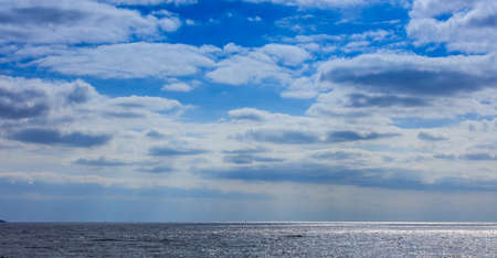 Blue sky with clouds and sea backgroundの写真素材