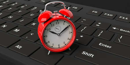 3d rendering red alarm clock on a black keyboardの写真素材