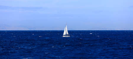 Boat sailing in blue seaの写真素材
