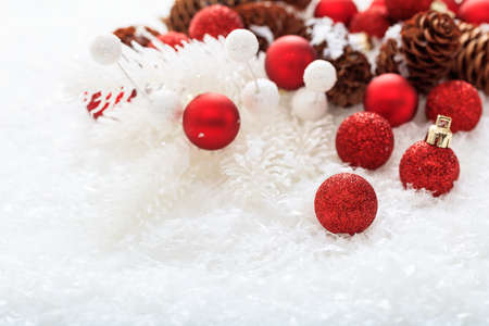 Red christmas balls and snow on white backgroundの写真素材