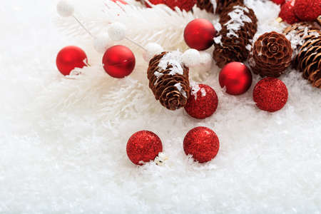 Red christmas balls and snow on white backgroundの写真素材