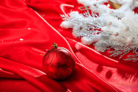 Red christmas ball on red satinの写真素材