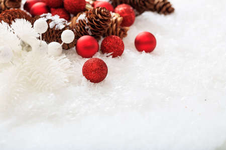 Red christmas balls and snow on white backgroundの写真素材