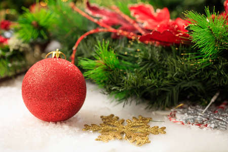 Red christmas ball and garland on white backgroundの写真素材