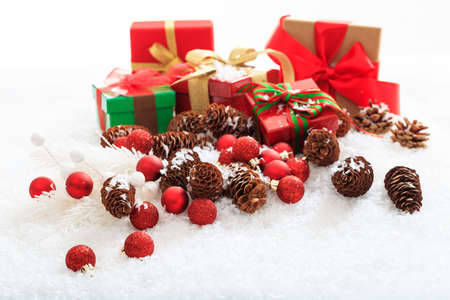 Gift boxes and balls on snow and white background
