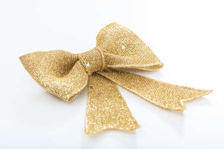 Golden bow isolated on white backgroundの写真素材