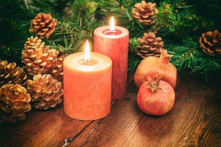 Candles and christmas decoration on a wooden backgroundの写真素材