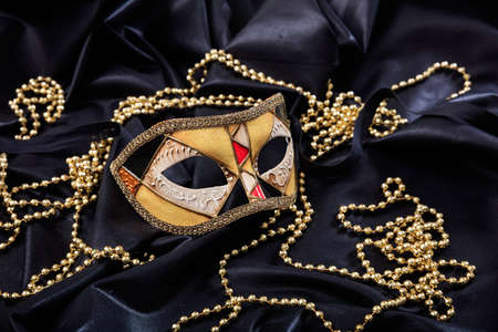 Carnival mask isolated on black satin backgroundの写真素材