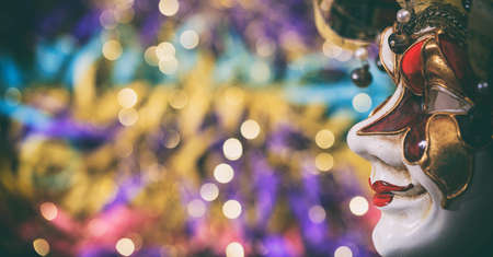 Harlequin carnival mask on colorful blur backgroundの写真素材
