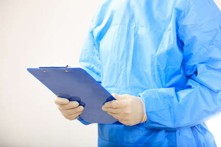 Surgeon holding a clipboard on white backgroundの写真素材