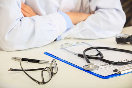 Young male doctor sitting in his officeの写真素材