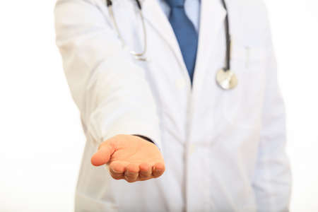 Doctor offering a hand standing on white backgroundの写真素材