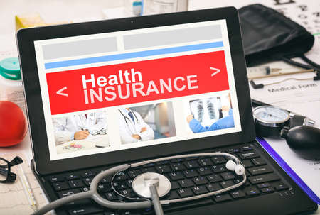 Health insurance on a computer's screen on a deskの写真素材