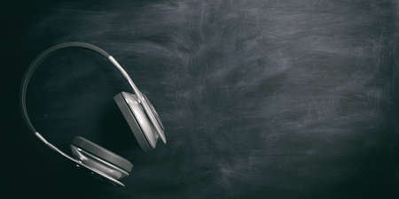 3d rendering pair of wireless headphones on a blackboardの写真素材