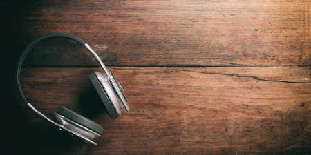 3d rendering pair of wireless headphones on wooden backgroundの写真素材