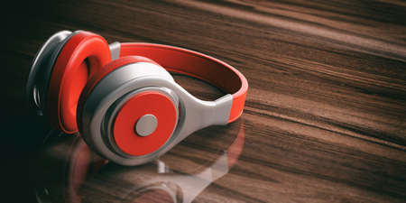 3d rendering pair of red wireless headphones on wooden backgroundの写真素材