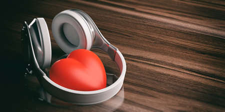 3d rendering pair of wireless headphones and a red heart on wooden backgroundの写真素材